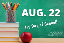 Stack of books with a can of color pencils and an apple in front of a chalkboard background. Text reads, "Aug. 22 1st Day of School".